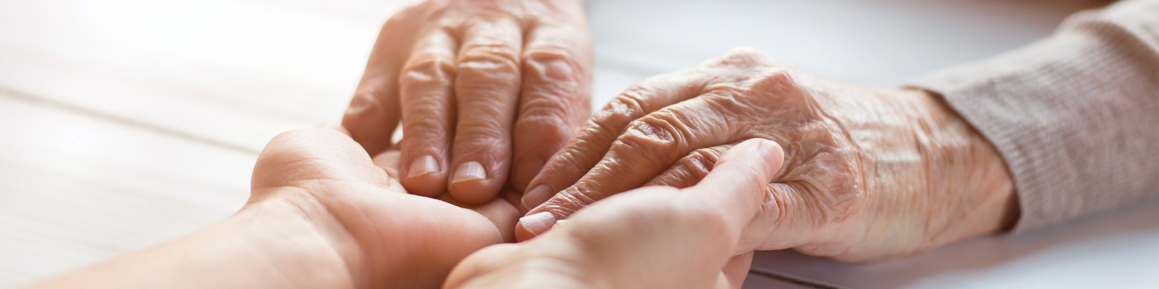 Die Hände eines älteren Menschen und die eines jüngeren halten einander. | © fotolia_halfpoint_80327224_xxl